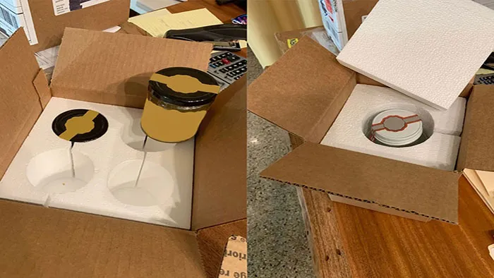 How does Crown Win's paper packaging solution prevent damage to glass products during transportation?