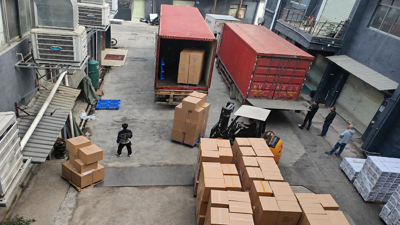 Crown Win Box Manufacturer factory yard loading finished custom paper packaging boxes into shipping containers, mass product launch packaging bulk delivery and logistics operation